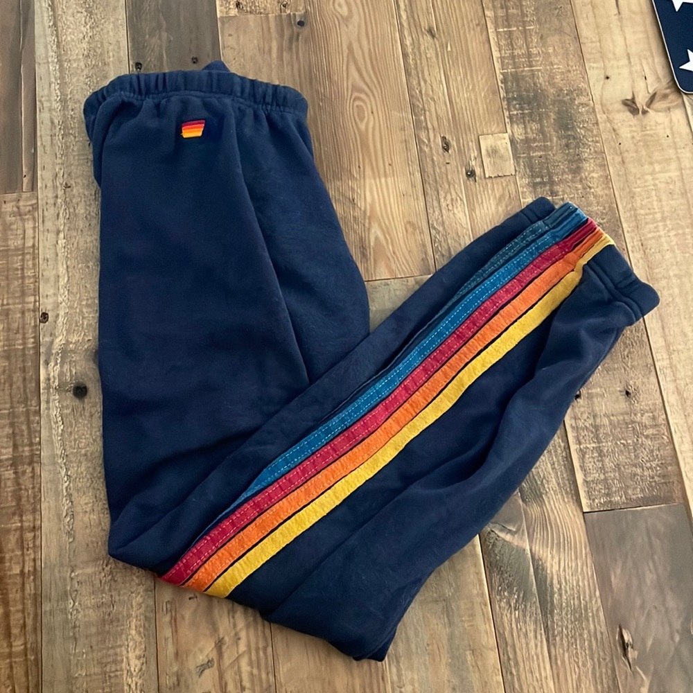 These are Aviator Nation sweats. They’re blue with multi-color stripes, size XS.